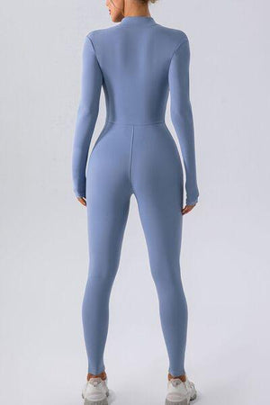 a woman in a light blue bodysuit