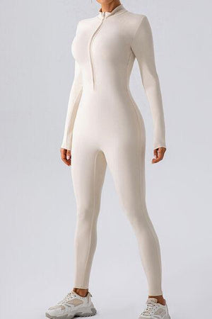 a woman in a white bodysuit is posing for a picture