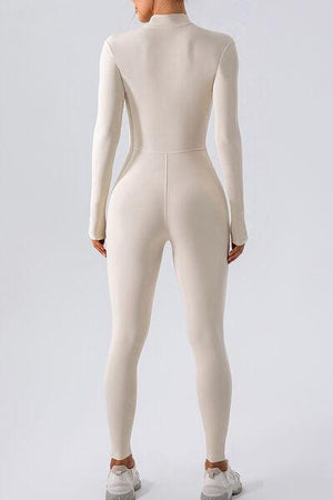 a woman in a white bodysuit is facing away from the camera