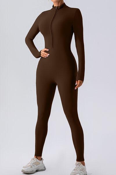 a woman in a brown bodysuit posing for a picture