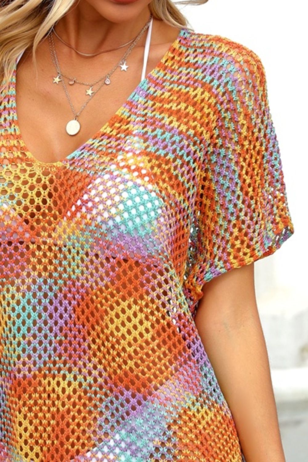 a woman wearing a multicolored top