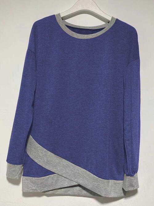 a blue sweater with a grey stripe on the side