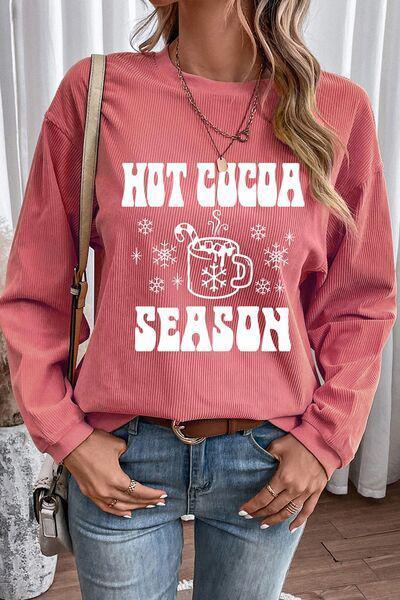 a woman wearing a red sweater that says hot cocoa season
