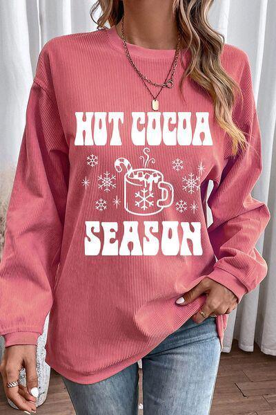 a woman wearing a hot cocoa season sweater