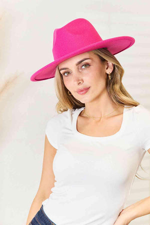 a woman wearing a bright pink hat