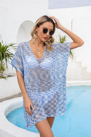 a woman standing next to a pool wearing a blue dress