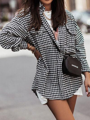 a woman in a black and white jacket and hat