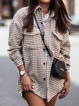 a woman wearing a shirt dress and a hat