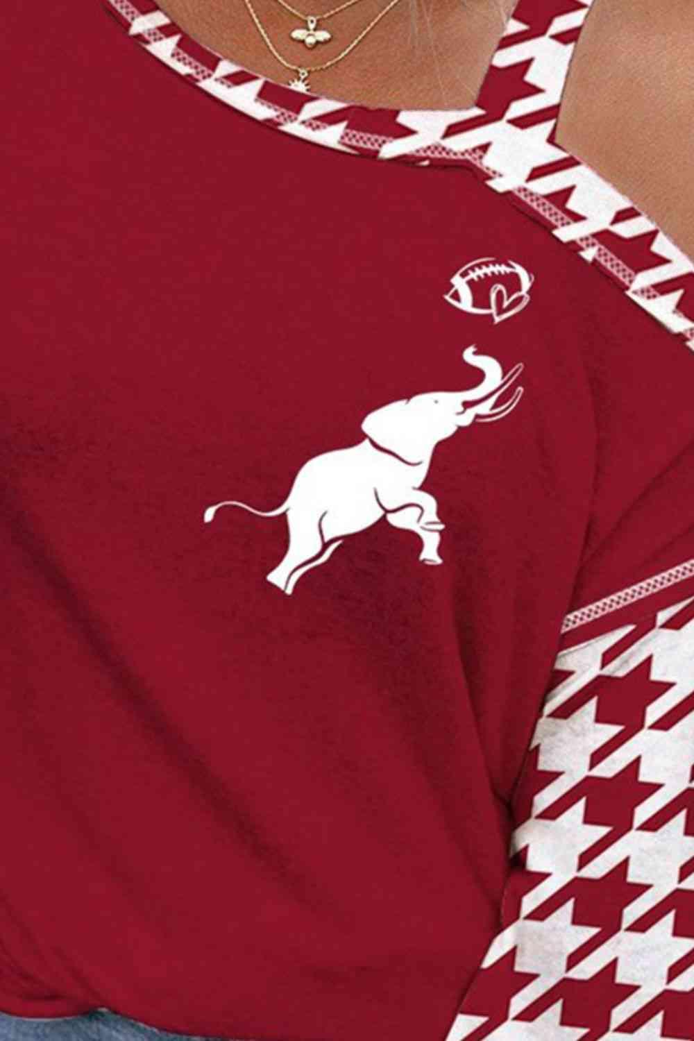 a woman wearing a red shirt with a white elephant on it