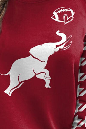 a woman wearing a red shirt with a white elephant on it