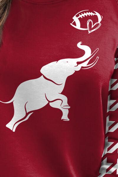 a woman wearing a red shirt with a white elephant on it