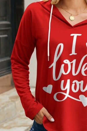 a woman wearing a red hoodie that says i love you