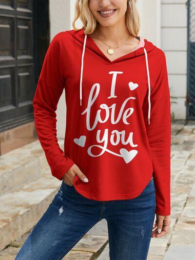 a woman wearing a red hoodie that says i love you