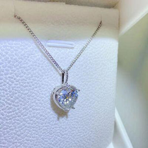 a necklace with a heart shaped diamond on it