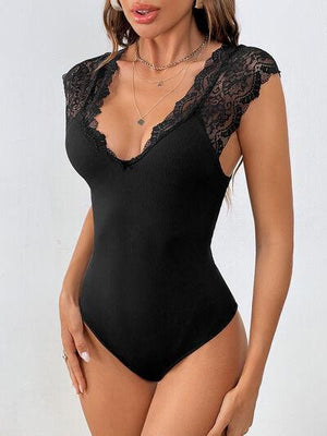 a woman in a black bodysuit posing for the camera