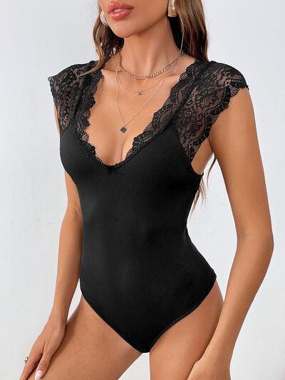 a woman wearing a black bodysuit with lace detailing
