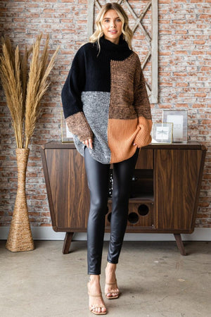 a woman standing in front of a brick wall