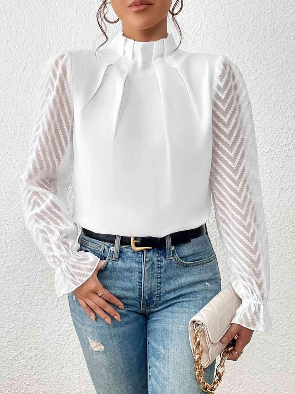 a woman wearing a white blouse and jeans