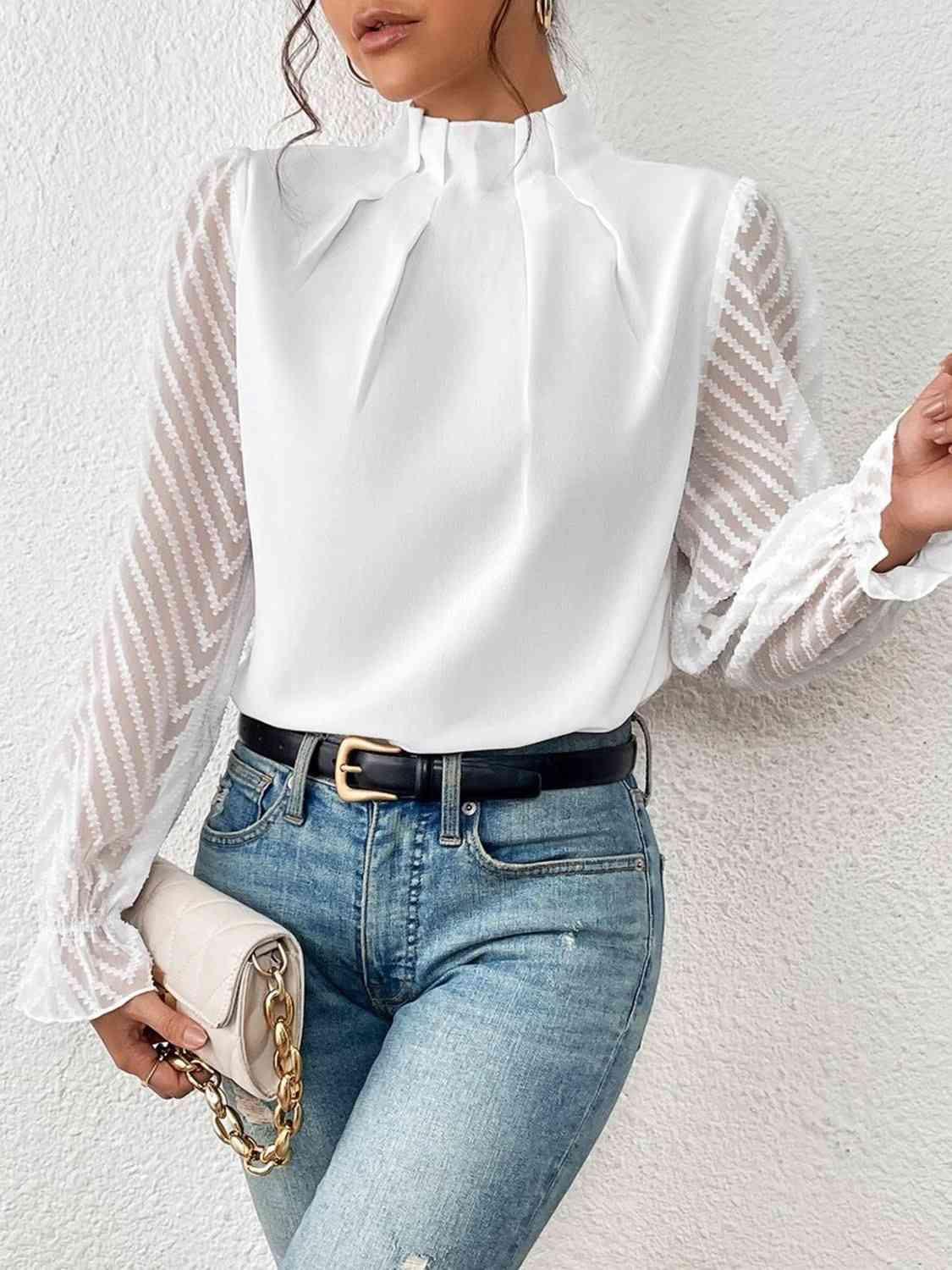 a woman wearing a white blouse and jeans