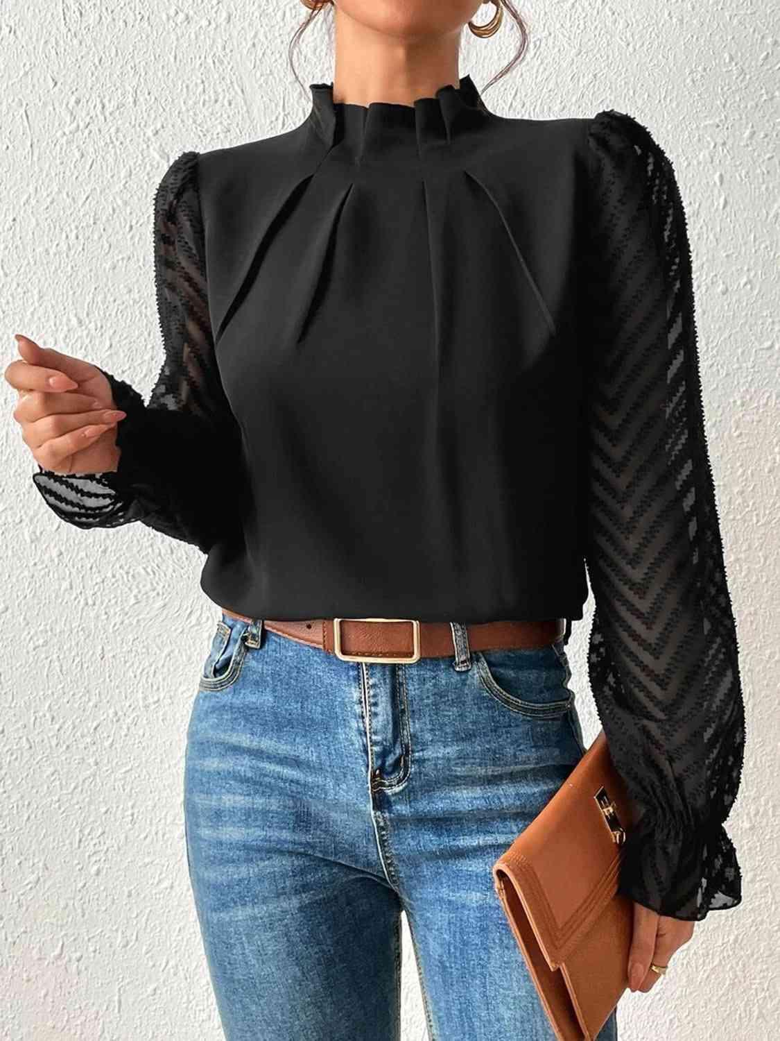 a woman wearing a black blouse and jeans