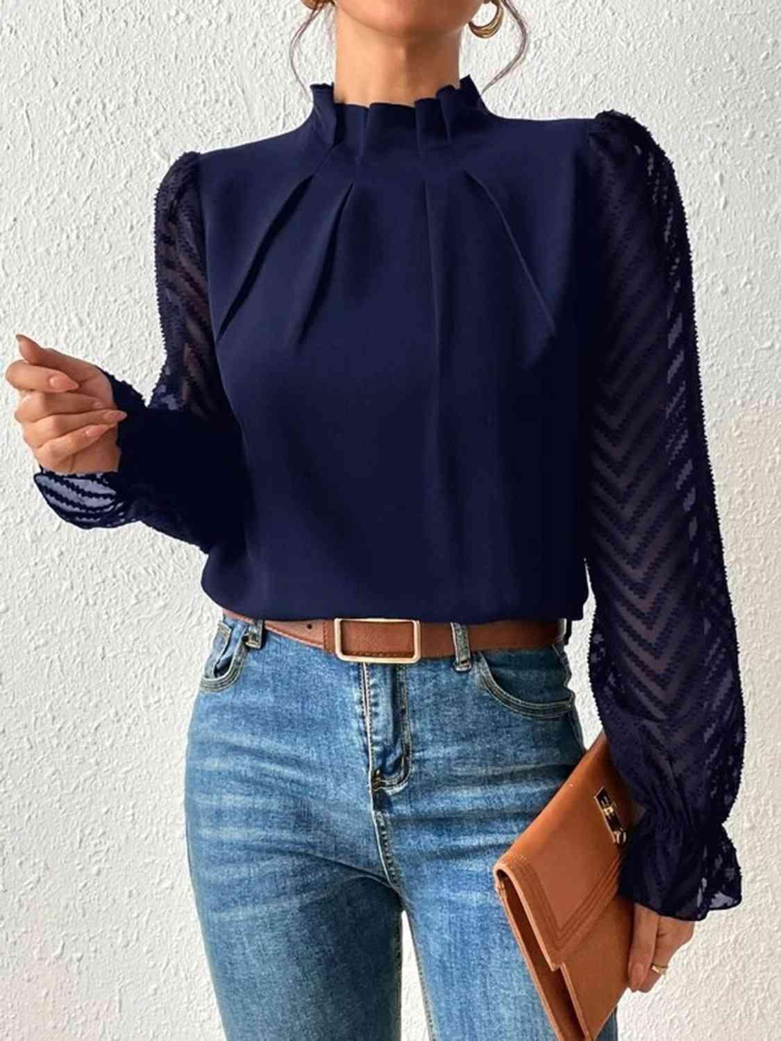 a woman wearing a blue blouse and jeans