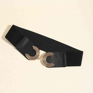 a black belt with two gold rings on it