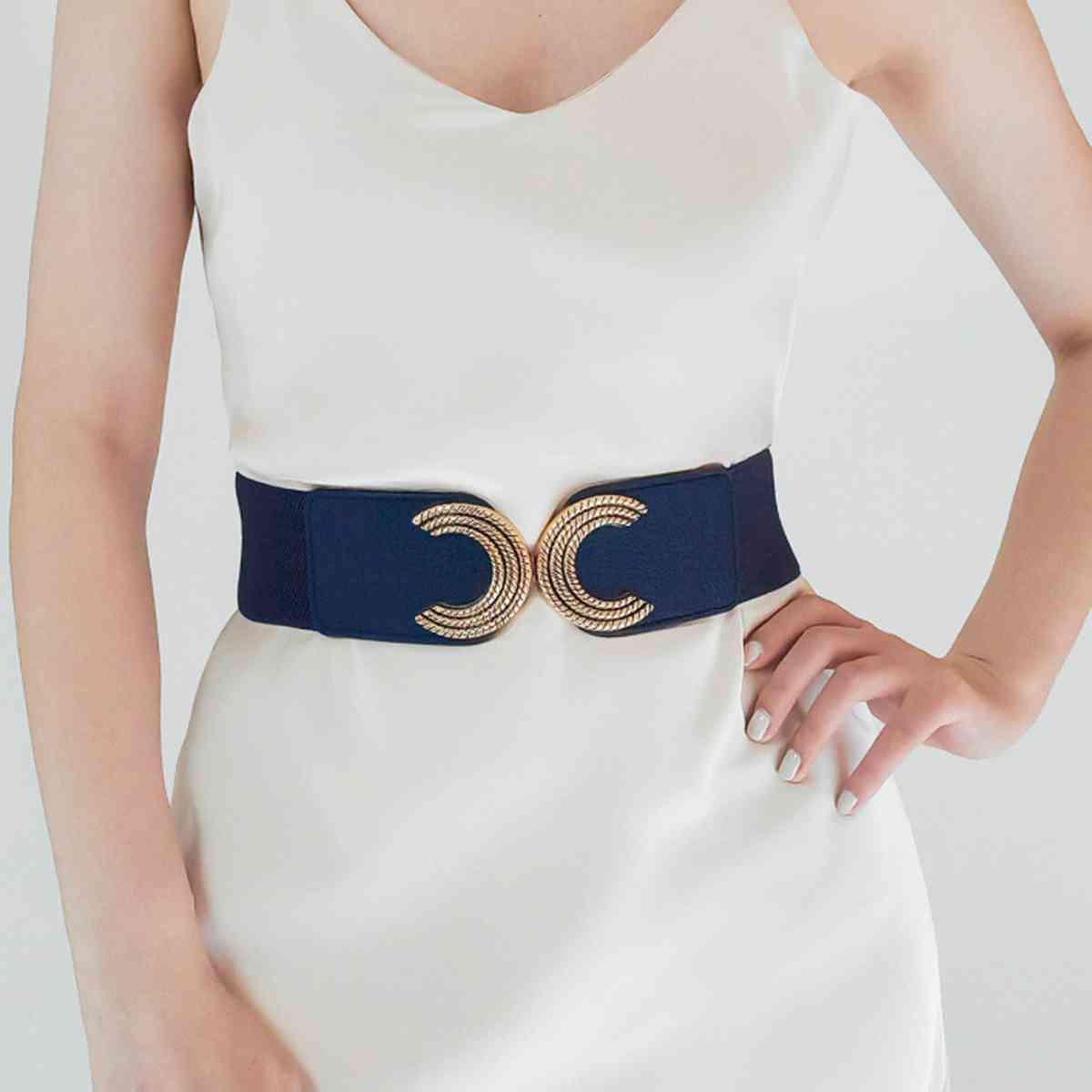 a woman wearing a white dress and a blue belt