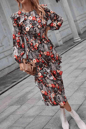 a woman wearing a floral dress and white boots
