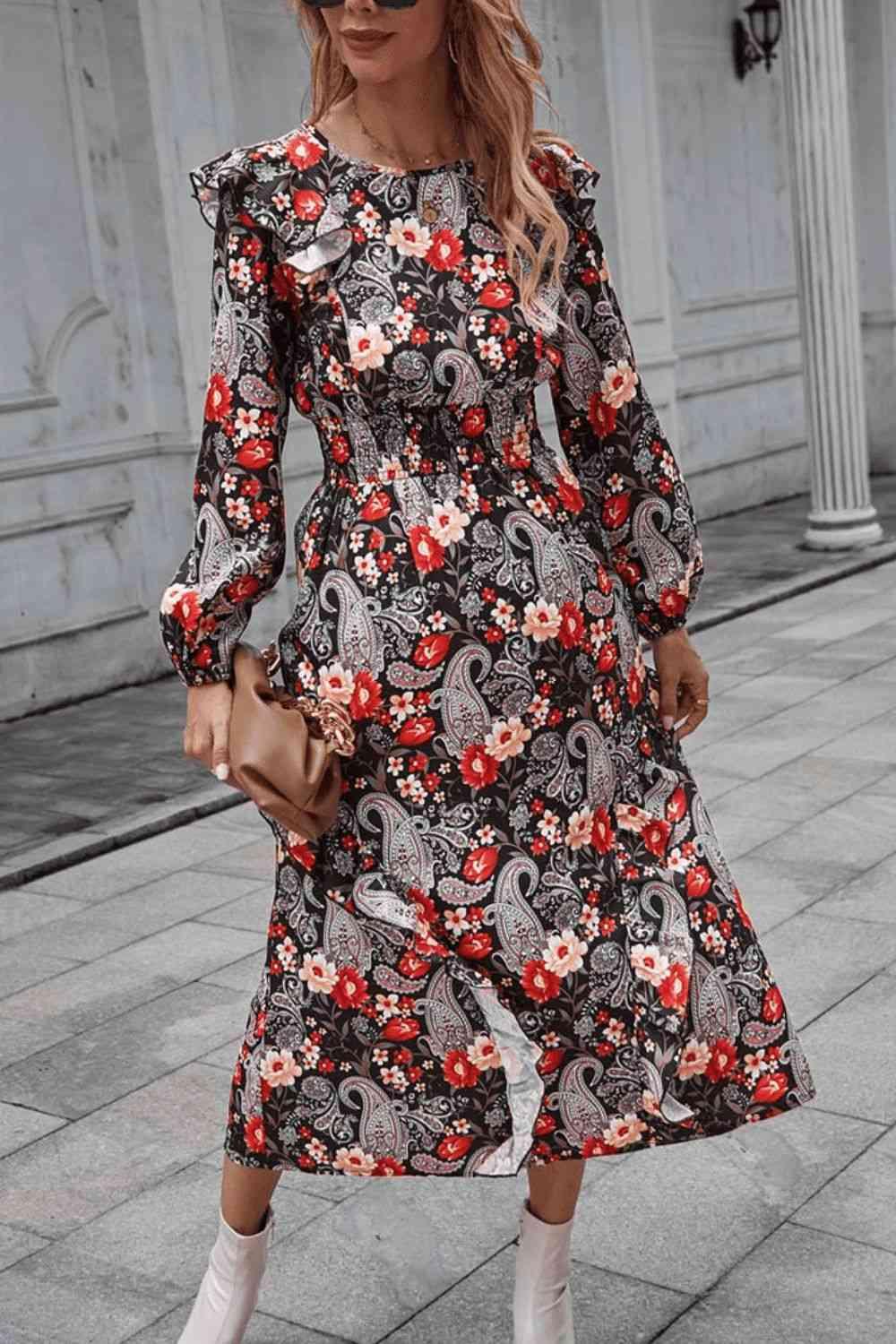 a woman wearing a black and red floral print dress