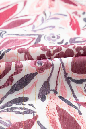 a close up of a pink and purple floral print fabric