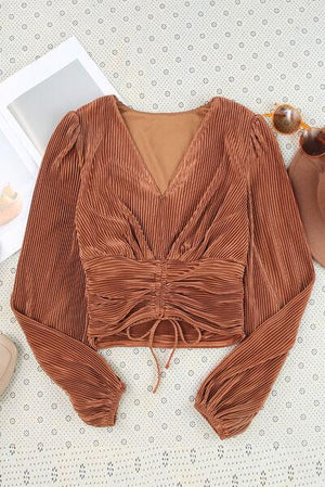 a brown top with a bow on the front