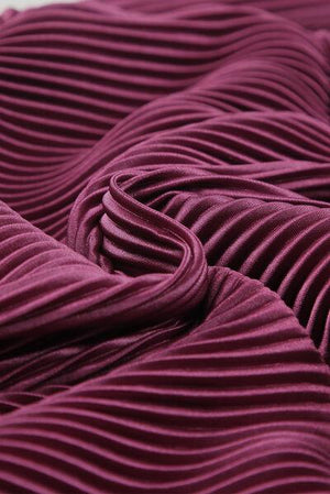 a close up of a purple fabric with wavy lines