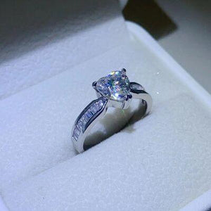 a ring with a princess cut diamond in a box