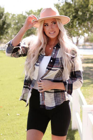 a woman wearing a hat and shorts posing for a picture