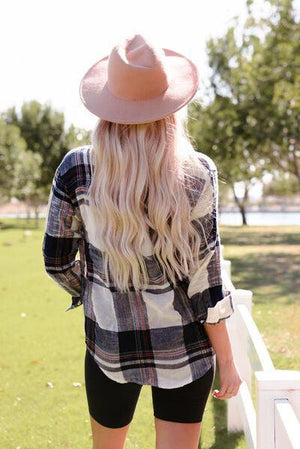 a woman with long blonde hair wearing a hat