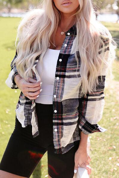 a woman with long blonde hair wearing a plaid shirt and black shorts