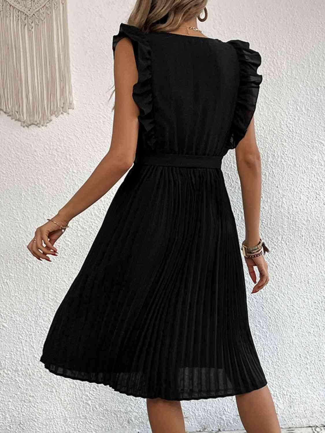 a woman wearing a black dress and heels