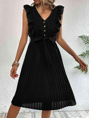 a woman wearing a black dress with a pleated skirt