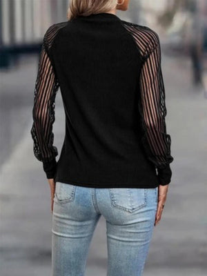 a woman wearing a black top and jeans