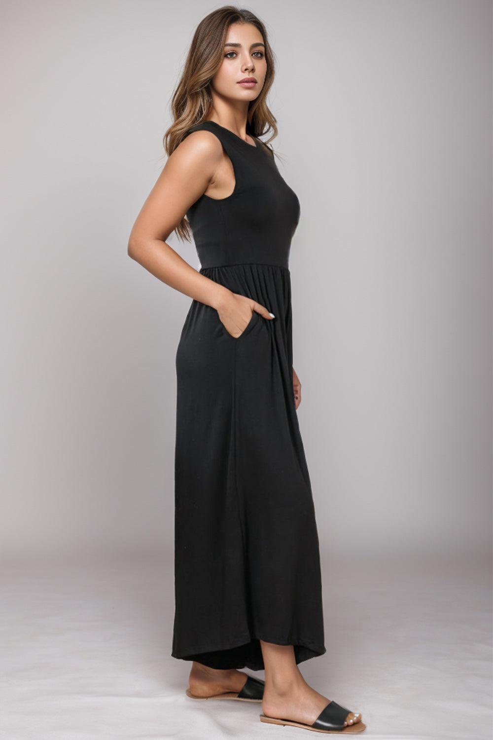 a woman in a black dress posing for a picture