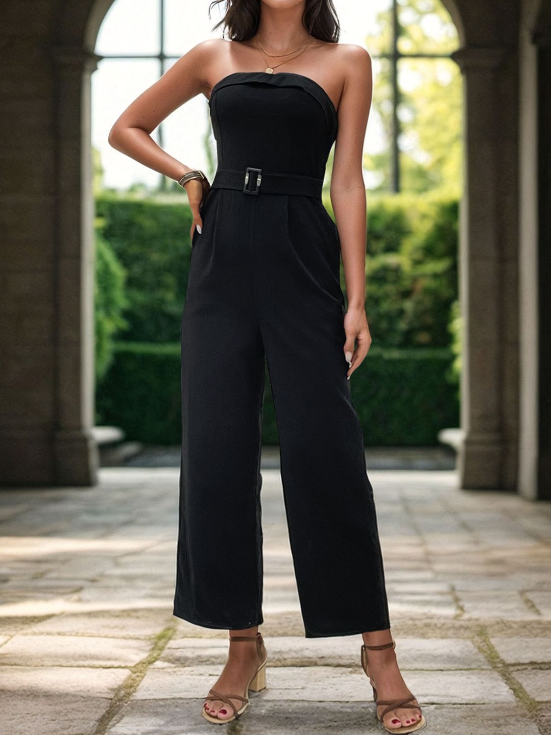 a woman in a black jumpsuit posing for a picture