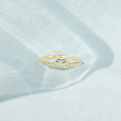 a close up of a gold ring on a white background