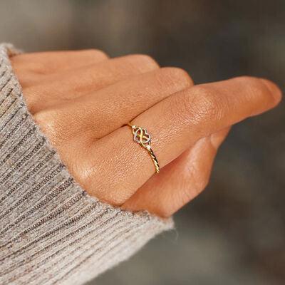 a woman's hand with a gold ring on it