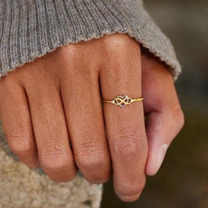 a close up of a person's hand with a ring on it