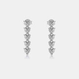 a pair of diamond earrings on a white background