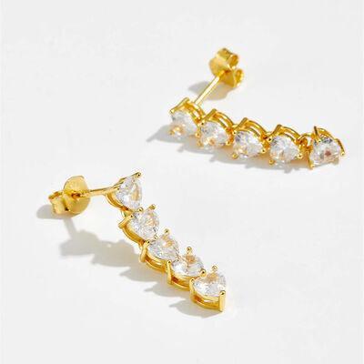 a pair of gold earrings with clear stones