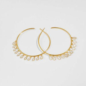 a pair of gold hoop earrings on a white background