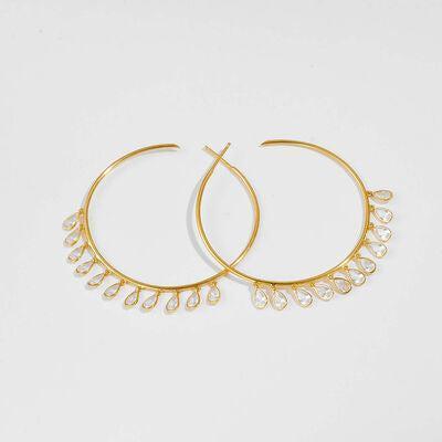 a pair of gold hoop earrings on a white background