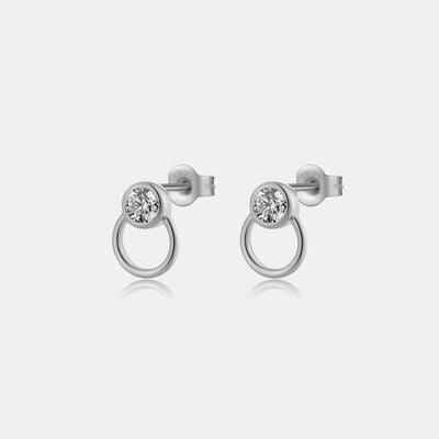 a pair of earrings with a single diamond