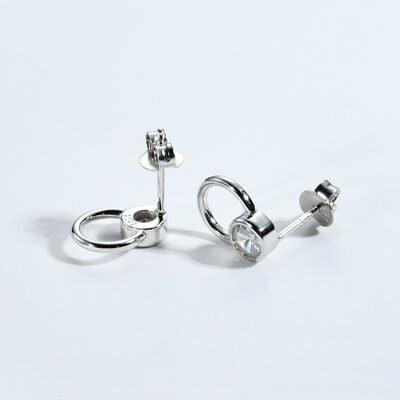 a pair of silver earrings on a white background